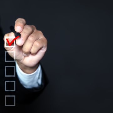 beenverified background check service men in suit checking boxes with red sign black background